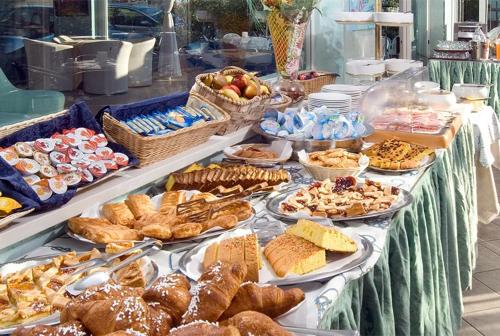 a buffet of bread and pastries on a table at Hotel Margareth in Riccione