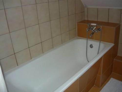 a bath tub with a shower in a bathroom at Apartment in Siofok/Balaton 19994 in Siófok