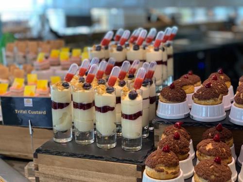 a display of desserts and pastries on a table at Royal M Hotel Abu Dhabi by Gewan in Abu Dhabi