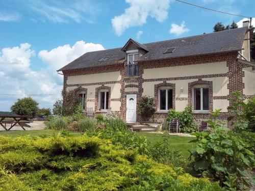 an old brick house with a garden in front of it at Le Cardonnet in Pont-Saint-Pierre
