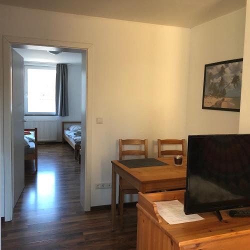 a living room with a table and a dining room at Mitte24 in Neu Ulm