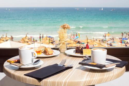a table with food and a view of the beach at Hotel Be Live Adults Only Marivent in Palma de Mallorca