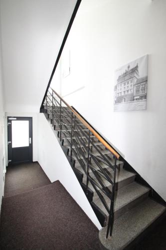 a staircase in a building with a picture on the wall at Penzion U Gigantu in Pilsen