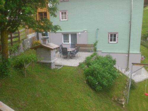 a patio with a table and chairs in front of a house at Ferienhaus Nadine in Kappl