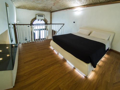 a bedroom with a bed in the middle of a room at IDEAL LOFT IN CENTRO TORINO in Turin