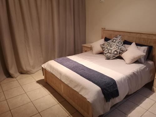 a bed with pillows on it in a bedroom at Seahorse unit 4 in Scottburgh