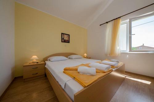 a bedroom with a large bed with a window at VILLA LIDIA in Mundanije