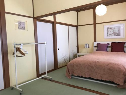 a bedroom with a bed and some windows at Naeba Ski Resort & Fuji Rock in Yuzawa