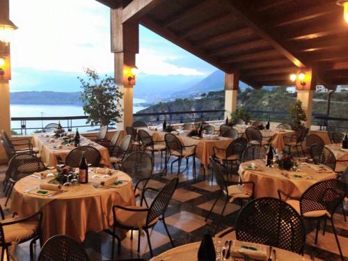 a restaurant with tables and chairs with a view at Hotel Villa Principe in San Nicola Arcella