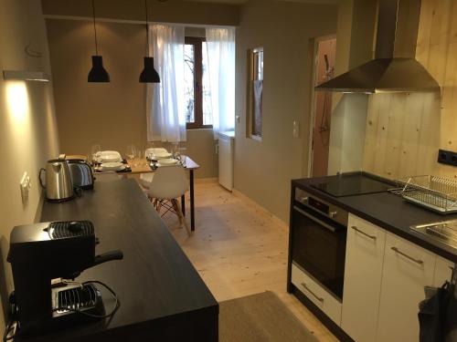 a kitchen with a black counter top and a table at Red Door Apartment in Sofia