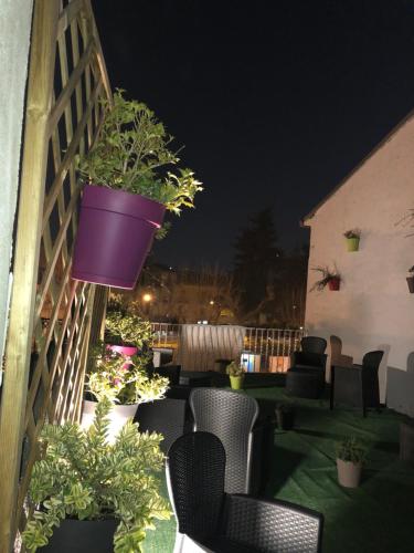 a patio with chairs and potted plants at night at Boutique Hotel Palazzo Corso Umberto in Boiano