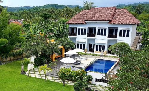 an aerial view of a house with a swimming pool at JM Hotel Kuta Lombok in Kuta Lombok