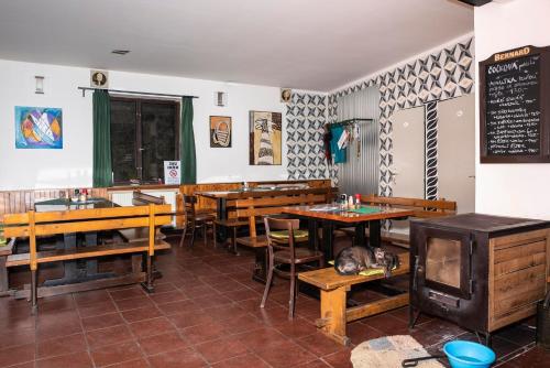 a restaurant with wooden tables and chairs and a chalkboard at U Kosti - Bohemian Switzerland in Děčín