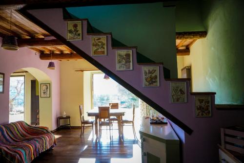 a staircase in a room with a table and chairs at La casina di Giannetto in Seggiano