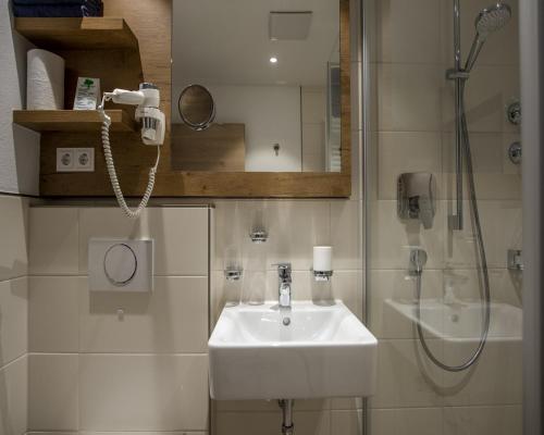 a bathroom with a sink and a shower at Gästehaus Boersch in Riezlern