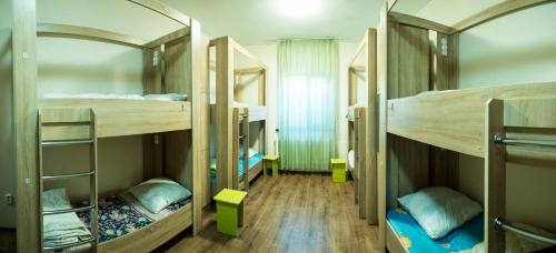 a room with three bunk beds in it at Hostel Nomad 4x4 in Astana