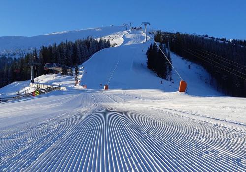 a snow covered ski slope with a ski lift at Chata 107 Tatralandia Village in Liptovský Mikuláš