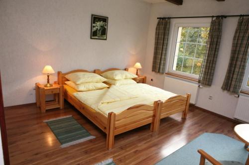 a bedroom with a large bed and a window at Mała Sowa in Rzeczka