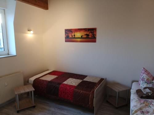 a small bedroom with a bed and a couch at Ferienwohnung Kopp V in Greiz