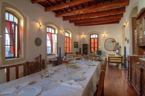 a dining room with a table with plates and glasses at Palazzo Di Acqua in Atsipopoulo