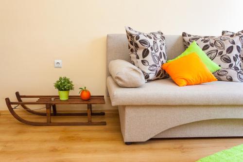 a living room with a couch and a coffee table at Green Orange Apartment in Bansko