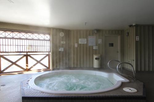 a large bath tub in a room with a window at Marketplace Lodge by Whistler Retreats in Whistler
