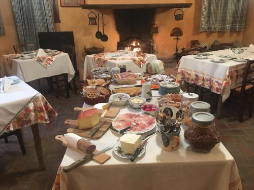 a table with food on it in a room with two tables at Agriturismo La Cascinetta in Pieve di Cento