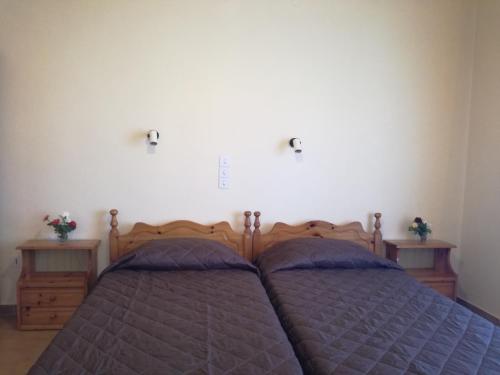a bedroom with two beds and two night stands at Tony studio & apartments in Laganas