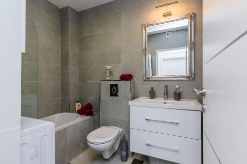 a bathroom with a toilet and a sink and a mirror at Superior apartment Nike in Mlini