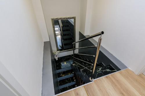 a staircase with a mirror in a room at Superior apartment Nike in Mlini