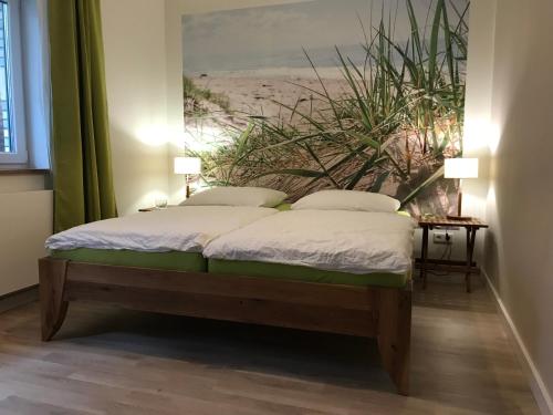a bedroom with a bed with a painting on the wall at SEASIDE APT. - BEACHHOUSE SOUL in Eckernförde