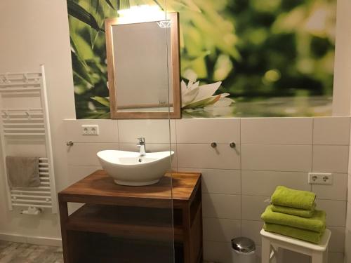 a bathroom with a sink and a mirror at SEASIDE APT. - BEACHHOUSE SOUL in Eckernförde
