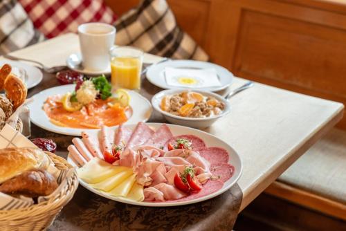a table topped with plates of food and drinks at Gasthof zum Stern in Seehausen am Staffelsee
