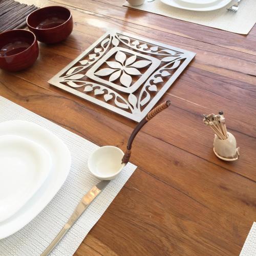 a table with white plates and a utensils on a wooden table at Villa Alice Caesarea in Caesarea