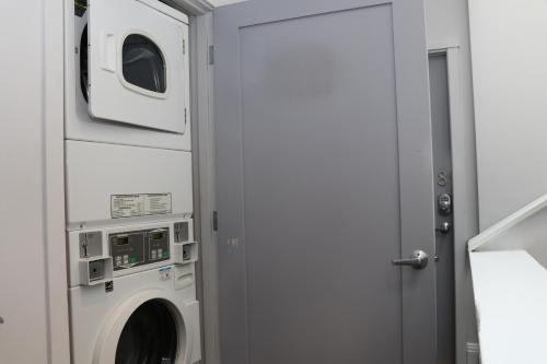 a laundry room with a washer and dryer at Furnished Newbury Street Studio, #6 in Boston