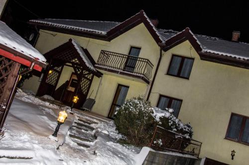 a large house with snow on the ground at Galant Hotel in Wieliczka