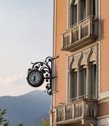 a clock attached to the side of a building at VISTA Lago di Como in Como