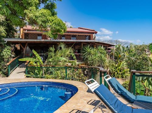 a house with a swimming pool and a resort at Villa Mango B&B in Nosara