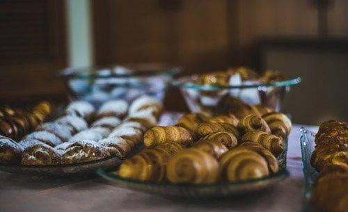 a table with three plates of different types of donuts at Mashabei Sade Kibbutz Country Lodging in Mashabbe Sade