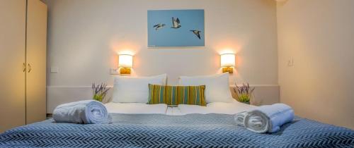 a bedroom with a large bed with two pillows at Mashabei Sade Kibbutz Country Lodging in Mashabbe Sade