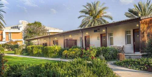 a house with a garden in front of it at Mashabei Sade Kibbutz Country Lodging in Mashabbe Sade