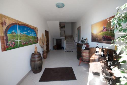 a living room filled with furniture and a staircase at Residence il Grappolo di Gavi in Gavi