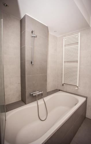 a white bath tub in a bathroom with a window at Ca Rossa - Venezia in Venice