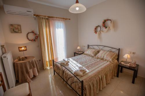 a bedroom with a bed with a dog laying on it at Elisso Apartment in Argostoli