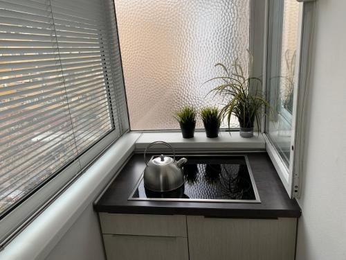 a kitchen with a tea kettle on a stove at ARSS Apartment Skopje Main Square in Skopje