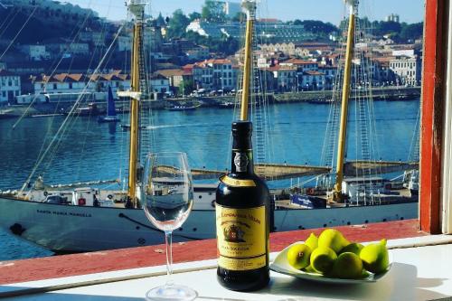 a bottle of wine and a glass on a table at Historic Oporto Apartment at oporto UNESCO area, in front of Porto Wine caves in Porto