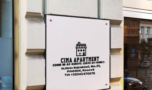 a sign on the side of a building at Cima Apartment in Pristina