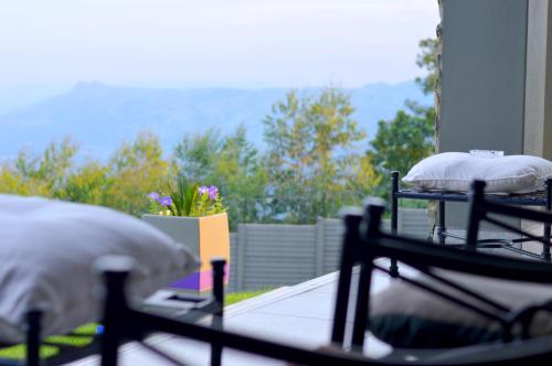 two beds with pillows on a balcony with a view at Rehoboth Mountain Suites in Mbabane