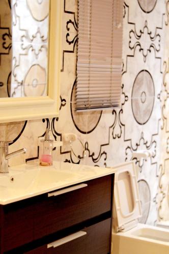 a bathroom with a sink and a mirror at Rehoboth Mountain Suites in Mbabane
