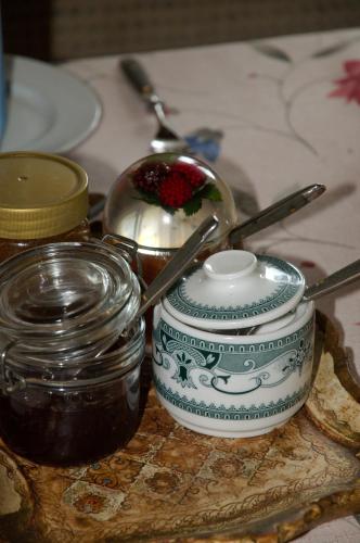 a table with a tea pot and a jar of jam at Landhaus Greiderer in Kössen